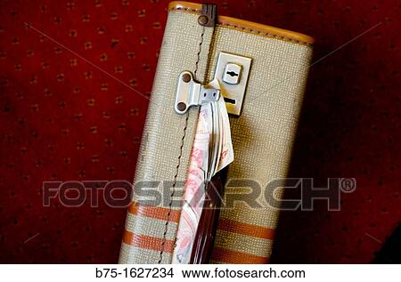 Picture - Old suitcase on the floor full of sterling notes. Fotosearch
