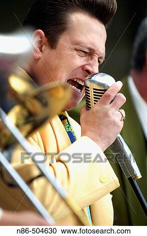 Old time swing band singer singing into microphone View Large Photo Image Stock Image - Old time swing band singer singing into microphone. Fotosearch