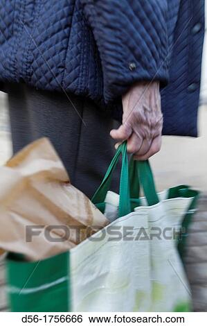 old woman carrying a bag, Valencia, Spain View Large Photo Image Stock Photograph - old woman carrying a bag, Valencia, Spain. Fotosearch
