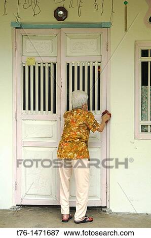 old woman cleaning her home in Chinatown in Georgetown, Penang, Malaysia View Large Photo Image Stock Photo - old woman cleaning her home in Chinatown in Georgetown, Penang, Malaysia. Fotosearch