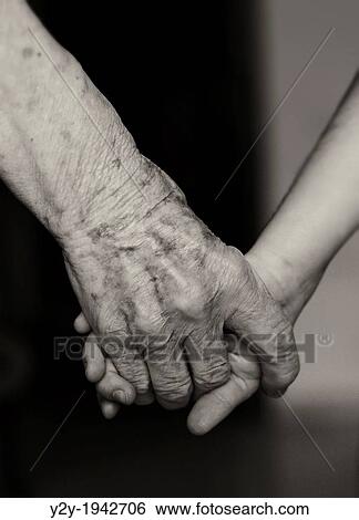 Stock Photograph - Old woman hand and young girl hand.. Fotosearch