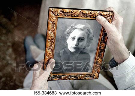 Old woman holding a frame View Large Photo Image Stock Image - Old woman holding a frame. Fotosearch