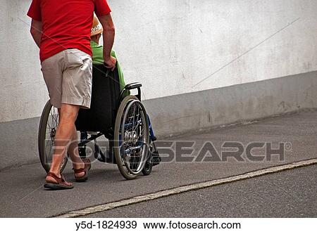 old woman in wheelchair, wheelchair pushed by a middle age man, street scene, summer, Switzerland View Large Photo Image Stock Photo - old woman in wheelchair, wheelchair pushed by a middle age man, street scene, summer, Switzerland. Fotosearch