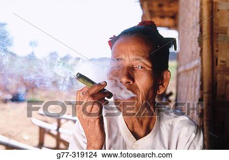 Picture - Old woman smoking a cheroot. Bagan. Myanmar (Burma). Fotosearch