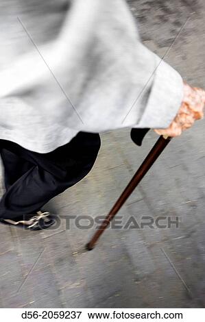 old woman walking with a cane. View Large Photo Image Stock Photo - old woman walking with a cane.. Fotosearch