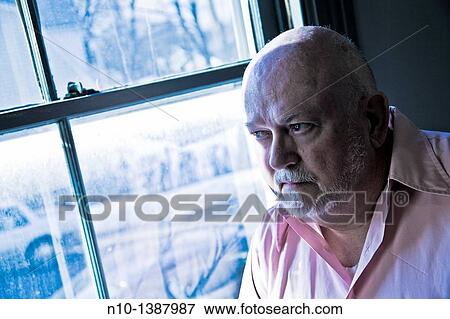 Stock Photo - Older man by a window. Fotosearch