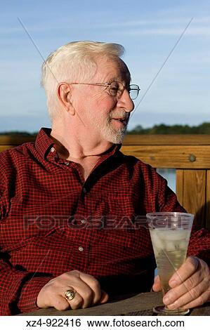 older man enjoys evening on dock View Large Photo Image Stock Photograph - older man enjoys evening on dock. Fotosearch