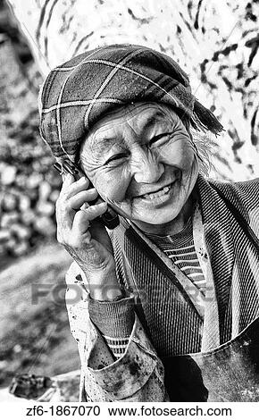 Older native woman on cell phone in rural Tibet China. View Large Photo Image Stock Image - Older native woman on cell phone in rural Tibet China.. Fotosearch