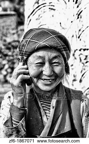 Older native woman on cell phone in rural Tibet China. View Large Photo Image Stock Image - Older native woman on cell phone in rural Tibet China.. Fotosearch