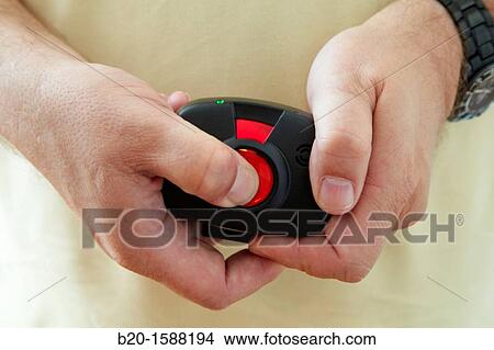 Older person's hand holding the device with a mobile tele care for automatic detection of falls that sits at the waist View Large Photo Image Picture - Older person's hand holding the device with a mobile tele care for automatic detection of falls that sits at the waist. Fotosearch