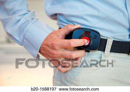Older person's hand holding the device with a mobile tele care for automatic detection of falls that sits at the waist View Large Photo Image Stock Photo - Older person's hand holding the device with a mobile tele care for automatic detection of falls that sits at the waist. Fotosearch