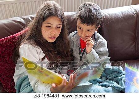 Older sister reading a story to her brother. View Large Photo Image Stock Image - Older sister reading a story to her brother.. Fotosearch