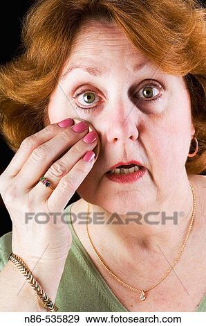 Older woman applying powder make up View Large Photo Image Stock Photo - Older woman applying powder make up. Fotosearch