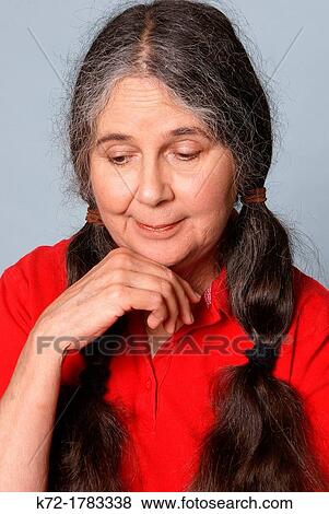Older woman looking down with pity and caring on her face View Large Photo Image Stock Photo - Older woman looking down with pity and caring on her face. Fotosearch