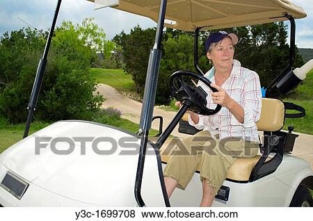 Older woman riding golf cart View Large Photo Image Stock Photo - Older woman riding golf cart. Fotosearch