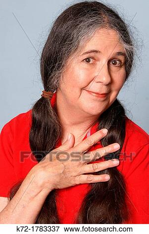 Older woman smiles with coy look on her face View Large Photo Image Stock Photo - Older woman smiles with coy look on her face. Fotosearch