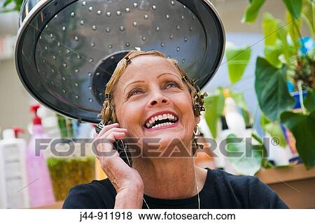 Older woman with hairclips using mobile phone, smiling, portrait View Large Photo Image Stock Photo - Older woman with hairclips using mobile phone, smiling, portrait. Fotosearch
