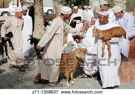 Stock Photo - Oman, Al-Dakhiliyah, Nizwa, livestock souq, goats, people.. Fotosearch