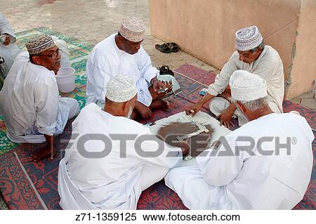 Oman, Muscat, Mutrah, men playing dominoes View Large Photo Image Stock Photography - Oman, Muscat, Mutrah, men playing dominoes. Fotosearch