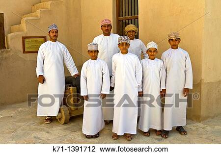 Stock Image - Omanian students at the Nizwa fort, Sultanate of Oman. Fotosearch