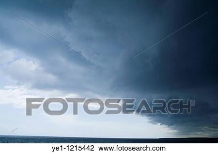Ominous storm clouds hover over the sea nearby Cienfuegos, Cuba. View Large Photo Image Stock Image - Ominous storm clouds hover over the sea nearby Cienfuegos, Cuba.. Fotosearch