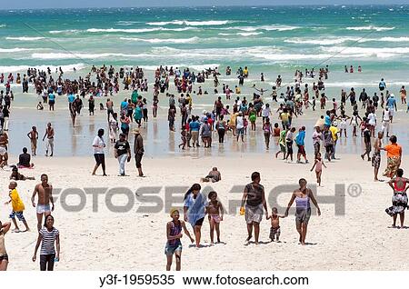 On a public holiday, people stream to the beach. A hot summer's day in Cape Town, South Africa View Large Photo Image Stock Photography - On a public holiday, people stream to the beach. A hot summer's day in Cape Town, South Africa. Fotosearch