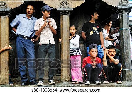 Picture - On the day of Gai Jatra festival in August at Durbar square Spectator watching the parade of the festival. Fotosearch