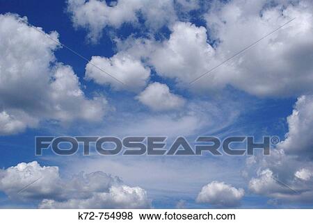 On this beautiful summer day white puffy clouds float around in a deep blue sky View Large Photo Image Stock Photo - On this beautiful summer day white puffy clouds float around in a deep blue sky. Fotosearch