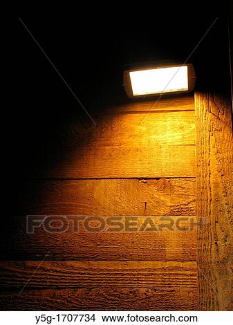 one bright light and high wooden wall at night View Large Photo Image Picture - one bright light and high wooden wall at night. Fotosearch