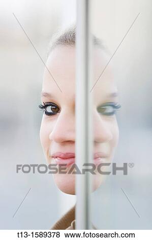 One-eye peek young woman portrait View Large Photo Image Stock Photo - One-eye peek young woman portrait. Fotosearch