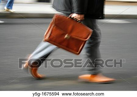 one male commuter carrying briefcase in town View Large Photo Image Picture - one male commuter carrying briefcase in town. Fotosearch