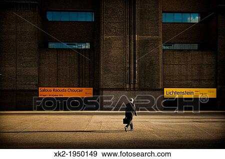One man walking fast paced in front of the Tate Modern main entrance, London, UK View Large Photo Image Stock Photo - One man walking fast paced in front of the Tate Modern main entrance, London, UK. Fotosearch