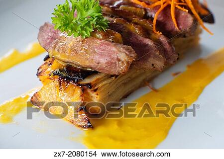Picture - One of the popular dishes of the restaurant Villa Angelique: Magret de canard et son gratin de patate douce et sa sauce "worth casting". 16 euros. Prepared by Chef Yves Atelin. Ingredients: (for 2 people). Duck with sweet potato and pineapple.. Fotosearch
