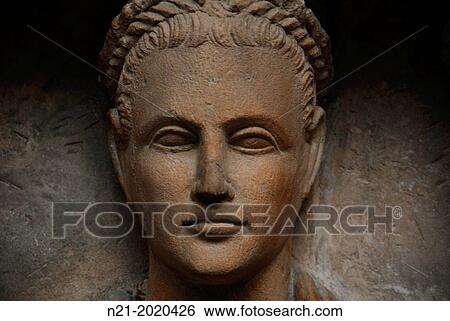 Stock Photograph - One of the three figures depicted in a limestone grave -relief made in Cyprus about 1st century AD from Tremithusa. British Museum, London, England, Great Britain, Europe.. Fotosearch