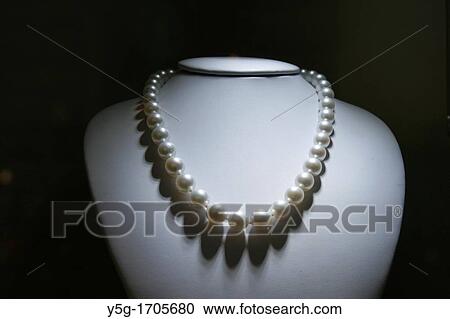 one pearl necklace on display in shop window View Large Photo Image Stock Image - one pearl necklace on display in shop window. Fotosearch