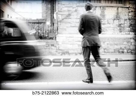 one unrecognizable executive crossing the street after a cab in London, England, UK, Europe View Large Photo Image Stock Image - one unrecognizable executive crossing the street after a cab in London, England, UK, Europe. Fotosearch