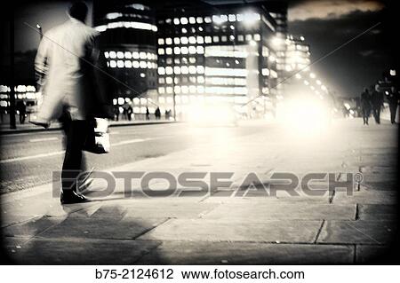 one unrecognizable executive with a portfolio walking in the street with traffic at night in London Bridge, London, England, UK, Europe. View Large Photo Image Stock Image - one unrecognizable executive with a portfolio walking in the street with traffic at night in London Bridge, London, England, UK, Europe.. Fotosearch
