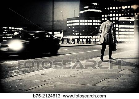 one unrecognizable executive with a portfolio walking in the street with traffic at night in London Bridge, London, England, UK, Europe View Large Photo Image Stock Image - one unrecognizable executive with a portfolio walking in the street with traffic at night in London Bridge, London, England, UK, Europe. Fotosearch