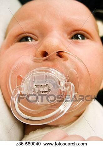 Stock Image - One week old girl with soother. Fotosearch