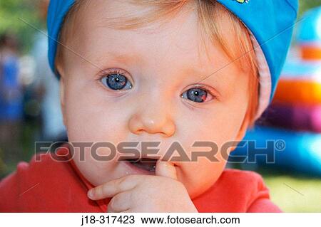 Stock Image - One year old baby girl at fair. Fotosearch