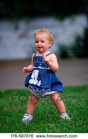 One year old baby girl holding a small stick. View Large Photo Image Stock Photograph - One year old baby girl holding a small stick.. Fotosearch