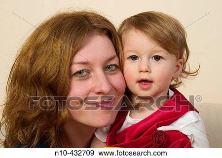 Stock Photo - One year old blond girl interacting with her mother. Fotosearch