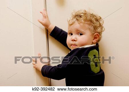 One year old boy at a bathroom door View Large Photo Image Stock Image - One year old boy at a bathroom door. Fotosearch