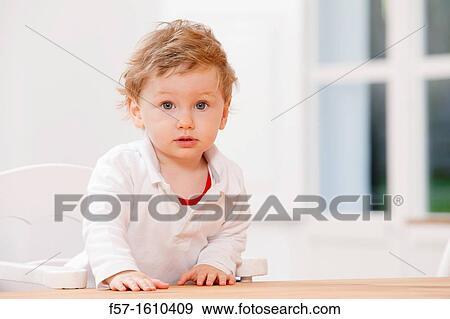 One year old boy in a high chair View Large Photo Image Stock Photo - One year old boy in a high chair. Fotosearch