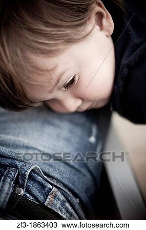 One year old boy laying on his father leg View Large Photo Image Stock Image - One year old boy laying on his father leg. Fotosearch