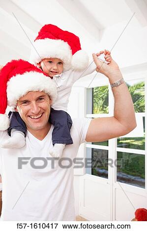 One year old boy on his fathers shoulders at Christmas time View Large Photo Image Stock Photo - One year old boy on his fathers shoulders at Christmas time. Fotosearch
