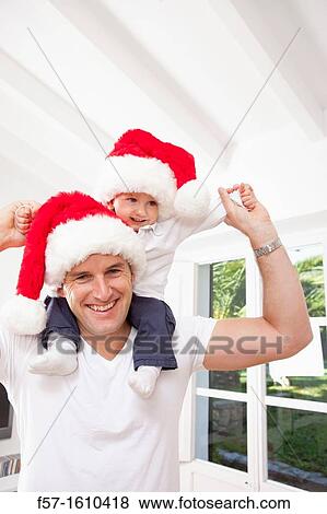 One year old boy on his fathers shoulders at Christmas time View Large Photo Image Stock Photo - One year old boy on his fathers shoulders at Christmas time. Fotosearch