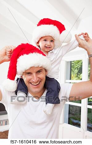 One year old boy on his fathers shoulders at Christmas time View Large Photo Image Stock Photograph - One year old boy on his fathers shoulders at Christmas time. Fotosearch