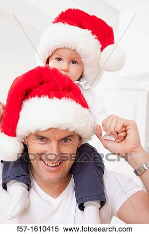 One year old boy on his fathers shoulders at Christmas time View Large Photo Image Stock Photography - One year old boy on his fathers shoulders at Christmas time. Fotosearch