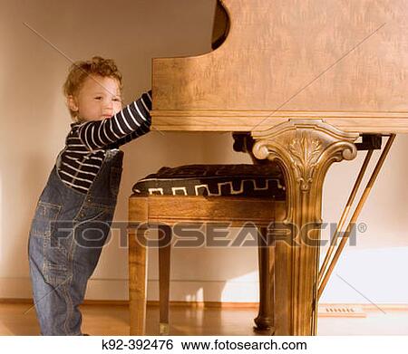 One year old boy playing a baby grand piano View Large Photo Image Stock Photograph - One year old boy playing a baby grand piano. Fotosearch